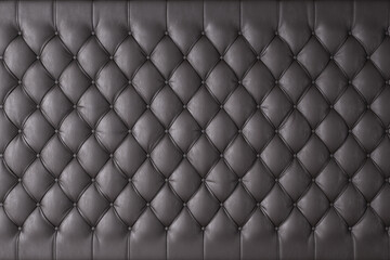 Black genuine leather upholstery, chesterfield style background. 3D rendering