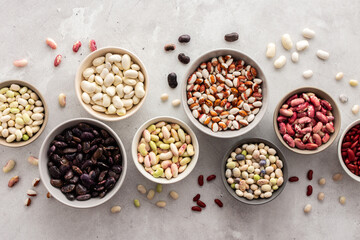 Different types of beans in bowls, economically important legume, top view, copy space