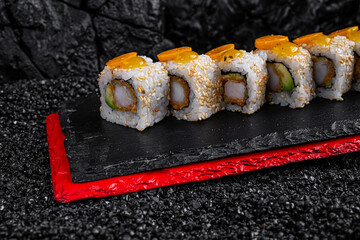 shrimp rolls on black background