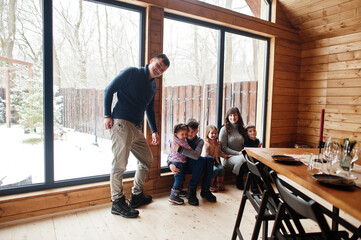 Fototapeta na wymiar Large family in modern wooden house spending time together in warm and love.