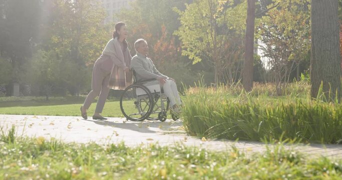 Senior Chinese woman with wheelchair bound husband,4K