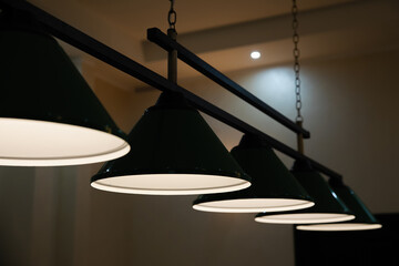 Large lamps over the billiard table.