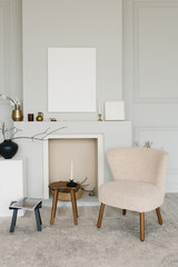 Fireplace, armchair and mockup paintings in the living room of a Scandinavian-style house