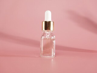 Pink Jar with serum and pipette on pink background.Cosmetology and beauty. Self care. Skin care product ad, luxury beauty cosmetics with Shining substance essence droplet. Beauty treatment nutrition