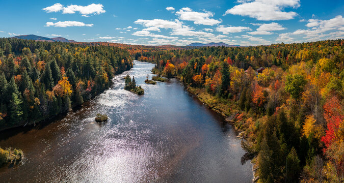 Colorful fall trees around the Saranac river near Redford in the Adirondacks in New York State in the autumn