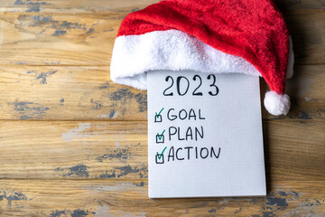 Notepad with plans for the next year and the inscription - 2023 goal, plan, action