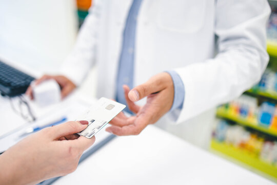 Woman Paying With Credit Card In Pharmacy Store
Paying Contactless
Wireless Paying 
Close Up