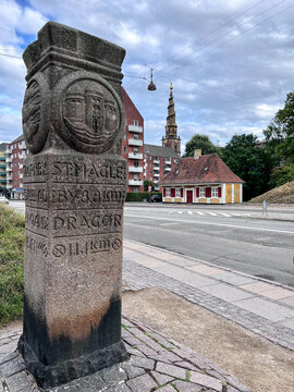 Historic Stone Milestone Marker By The Side Of Road With Our Saviour's Church (Vor Frelsers Kirke) In Distance, Christianshavn, Copenhagen, Zealand, Denmark