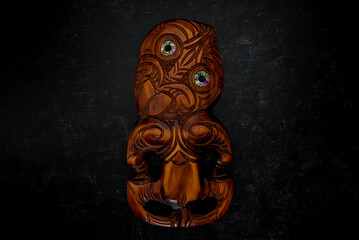 Wooden Maori Hei Tiki hand carved with paua shell eyes. New Zealand taonga.