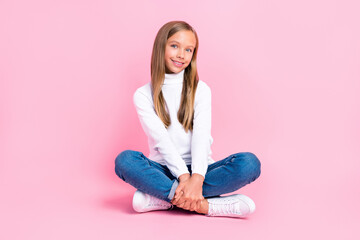 Full size photo of cheerful adorable person sit floor crossed legs isolated on pink color background