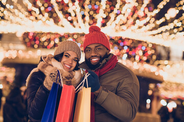 Portrait of attractive affectionate cheerful couple buying things center mall store festal eve time...