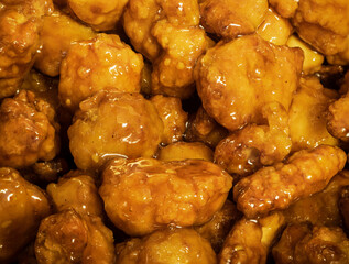 Fried chicken pieces with orange sauce