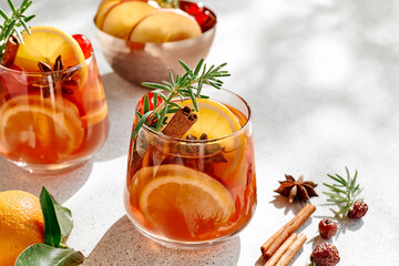 Mulled wine or christmas sangria with aromatic spices, apple, cherry and citrus fruits. Traditional Christmas festive warming spiced drink with orange, berry, cinnamon, cardamom and anise.
