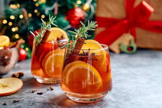 Mulled wine or christmas sangria with aromatic spices, apple, cherry and citrus fruits. Traditional Christmas festive warming spiced drink with orange, berry, cinnamon, cardamom and anise.