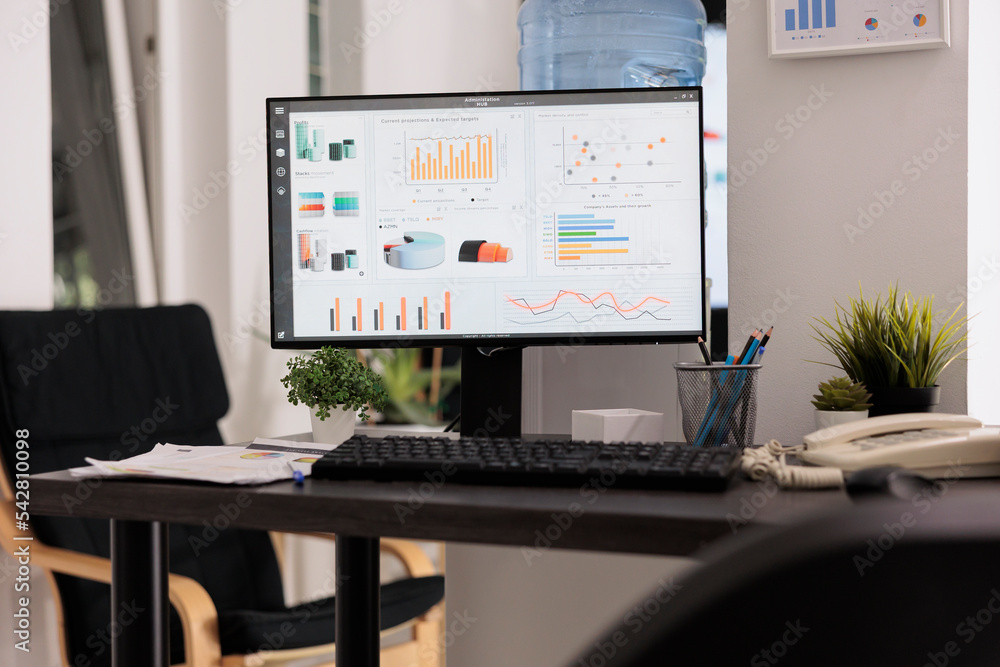 Poster desktop computer running financial management software on office desk. screen showing cost analysis 