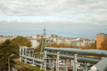 pipeline, in the photo the pipeline is close-up, in the background the city and buildings