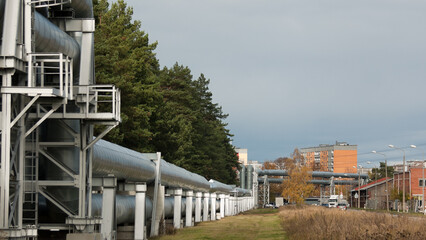 pipeline, in the photo the pipeline is close-up, in the background the city and buildings