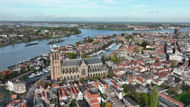 City center of Dordrecht, Dordt, South Holland, The Netherlands skyline along the Oude Maas river canal. Grote Kerk and historic traditional heritage city town. Aerial drone over view.