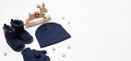 Collection of cute organic baby clothes and booties. Warm hat, mittens and boots