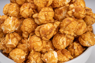 Close up, Caramel Popcorn in white bowl on wooden background, Caramel Mushroom Popcorn wooden background.