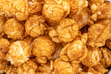 Close up, Caramel Popcorn in white bowl on wooden background, Caramel Mushroom Popcorn wooden background.