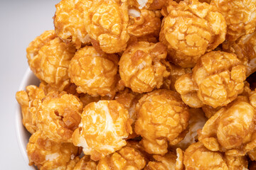Close up, Caramel Popcorn in white bowl on wooden background, Caramel Mushroom Popcorn wooden background.
