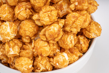 Close up, Caramel Popcorn in white bowl on wooden background, Caramel Mushroom Popcorn wooden background.