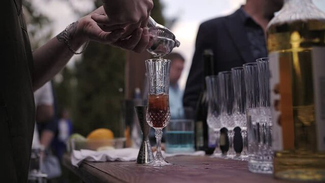 bartender prepares a cocktail outside