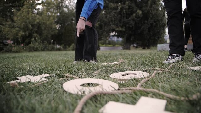 a company of people playing tic-tac-toe, outdoor play