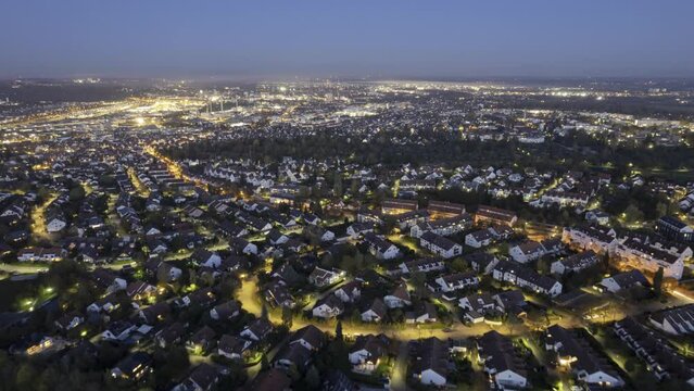 Western part of city of Ulm at dusk with city lights aerial time lapse