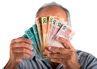 Man holding Brazilian money banknotes in front of his face. png transparent background