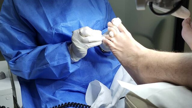 Professional pedicure. Podologist give a procedure of cleaning the toes of a customer. Close up. The concept of podology and chiropody.