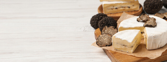 Soft cheese and fresh truffles on white wooden table, space for text. Banner design