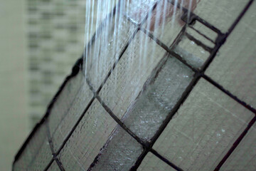Asian woman cleaning a dirty and dusty air conditioning filter in her house. Housewife removing a...