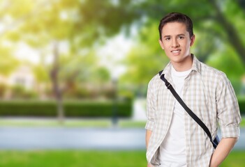 Young man in casual clothes on park background