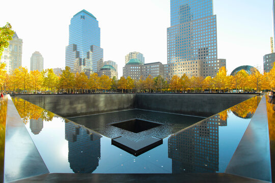 New York, NY - October 28, 2022: Ground Zero 911 World Trade Center memorial site with reflections of nearby buildings.