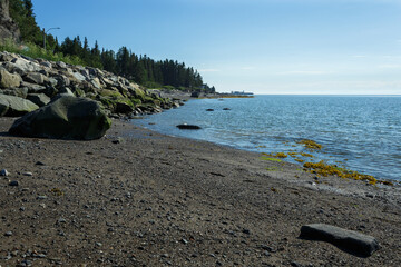 Rivière-du-Loup dock for ferry and people on the beach bathing. Parc de la pointe, Quebec Canada