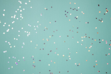 Christmas confetti over the mint background. 