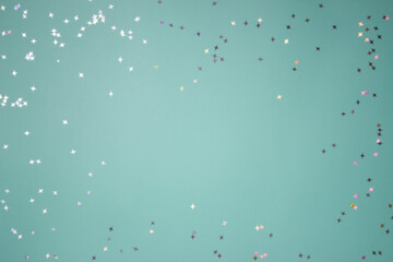 Sliver confetti over the mint background with copy space. 