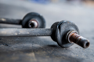 Close-up of worn out ,broken car front stabilizer sway bar link. 