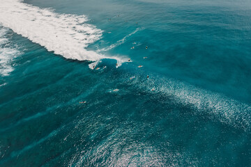 Aerial view with surfing on wave. Perfect waves with surfers in ocean