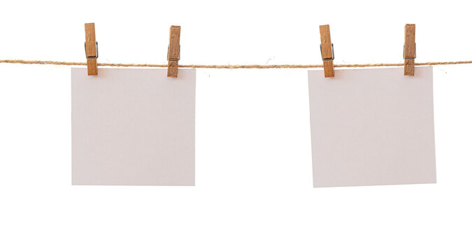 Two frames that hang on a rope with clothespins and isolated on white. Blank cards on rope mockup template