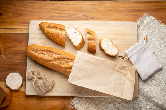 Baked baguette and multigrain loaf bread in Paper bag ready to serve.