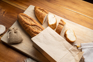 Baked baguette and multigrain loaf bread in Paper bag ready to serve.