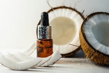 Split coconuts with coconut essential oil.  Coconut serum for the face.   A bottle of whey oil with...