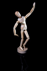 Image of wooden manikin on black background poses different posing
