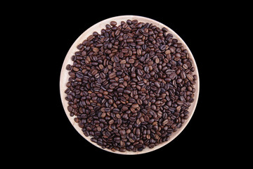 Coffee beans on the wood tray top view on black background