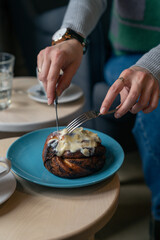 Female ready to eat cinnamon roll topped with lemon cream