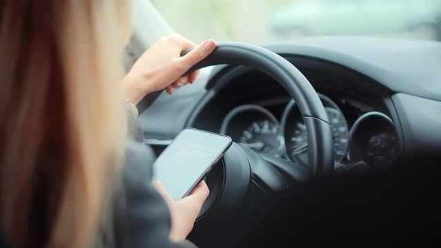 Checking Email Chats And Reading News. Female Writing Message In Vehicle On Social Network Chats On Cellphone. Texting And Driving Car On Social Media. Woman Texting On Smartphone While Driving Car.