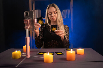 Female fortune teller reads tarot cards for predictions, telling customers by providing services...